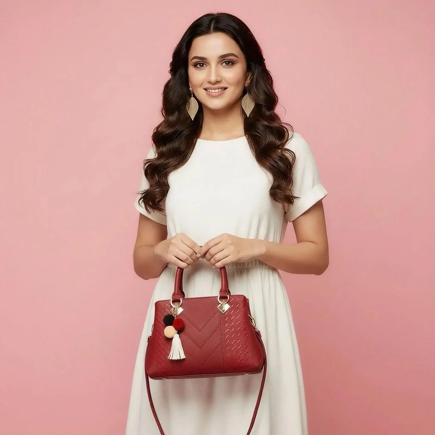 Woman holding a red handbag against a pink background