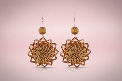 Pair of woven wooden earrings on a white background