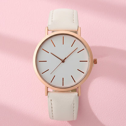 Wristwatch with rose gold case and beige strap on white background