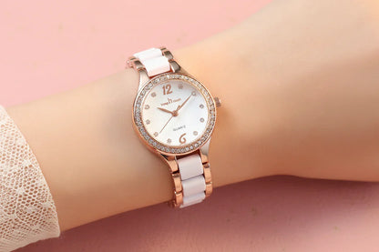 Rose gold watch with diamond accents on a wrist against a dark background