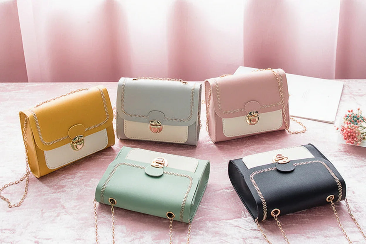 Five colorful handbags on a white surface with a light gray background