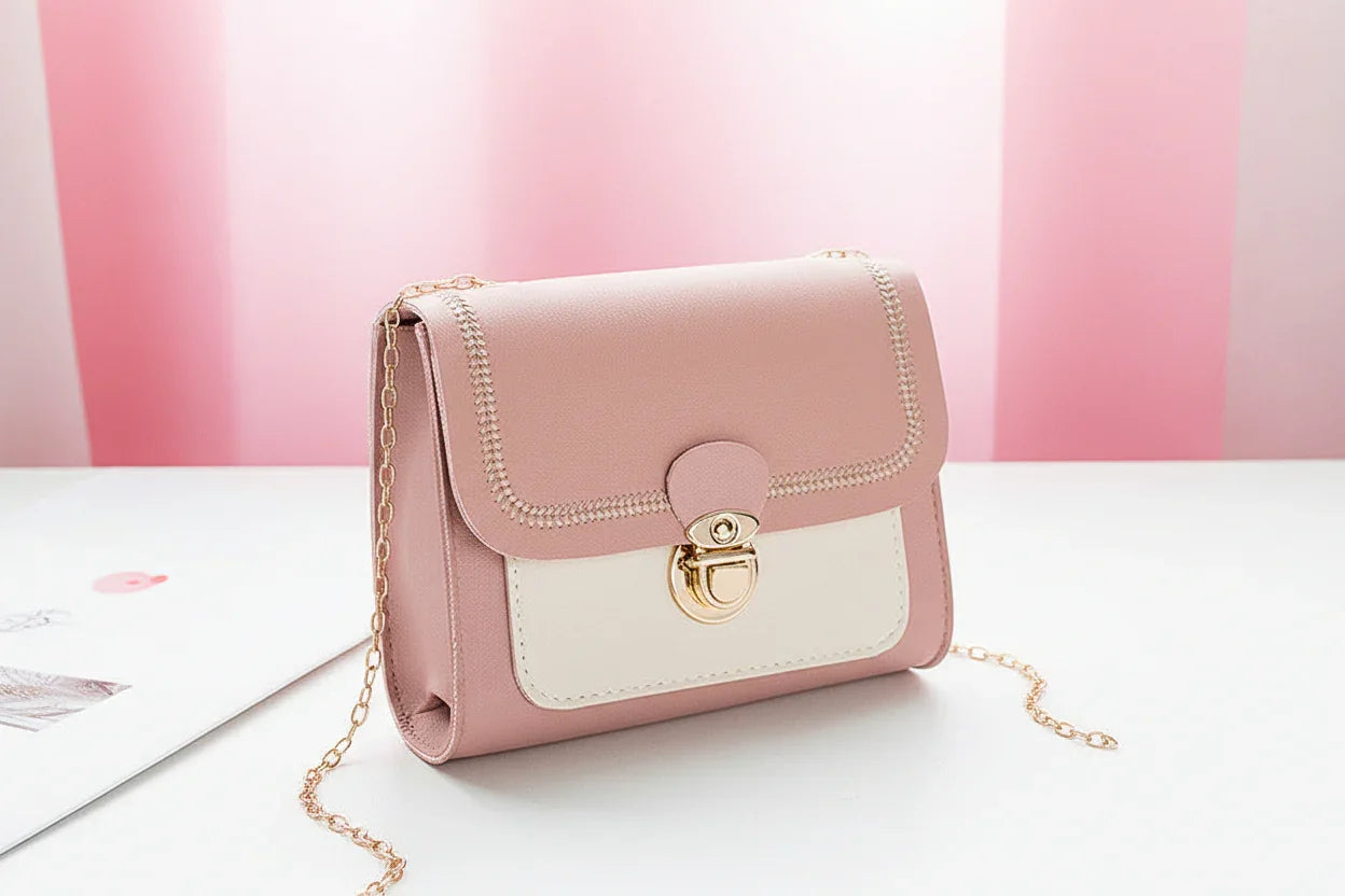 Pink handbag with a gold chain on a white background