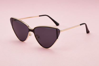 Sunglasses with gold frame and dark lenses on a white background