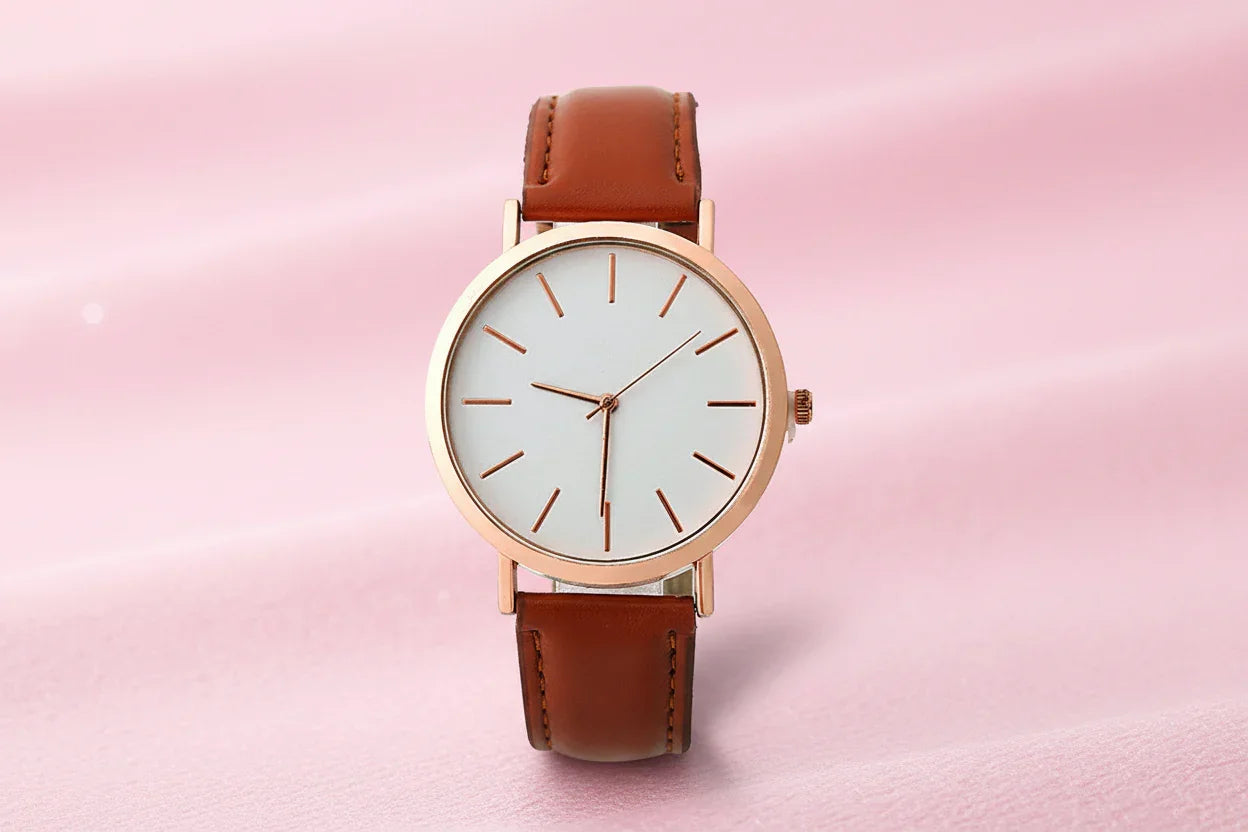Wristwatch with brown leather strap and rose gold case on white background