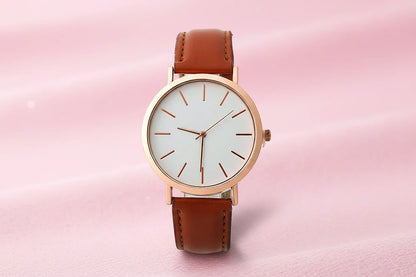 Wristwatch with brown leather strap and rose gold case on white background