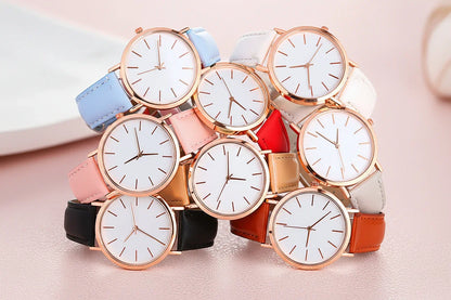 Multiple watches with different colored straps on a white background