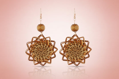 Pair of woven wooden earrings on a white background