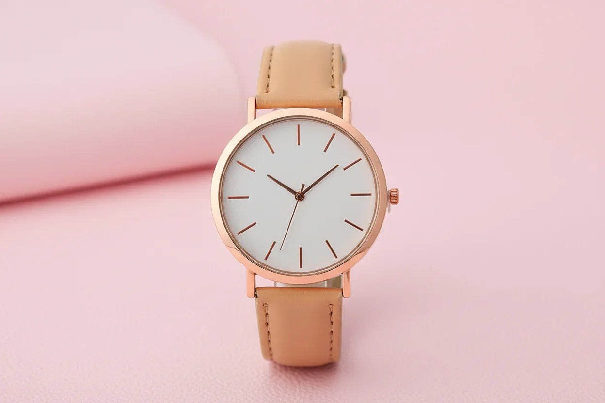 Wristwatch with beige strap and rose gold case on white background