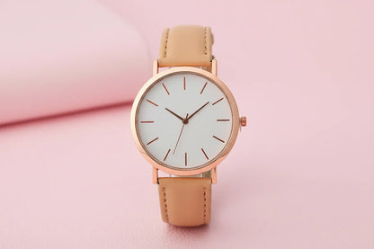 Wristwatch with beige strap and rose gold case on white background