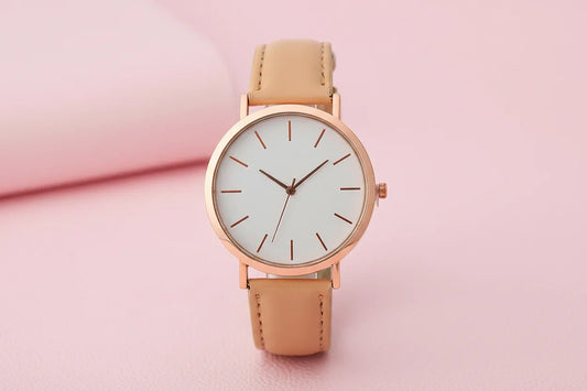 Wristwatch with beige strap and rose gold case on white background