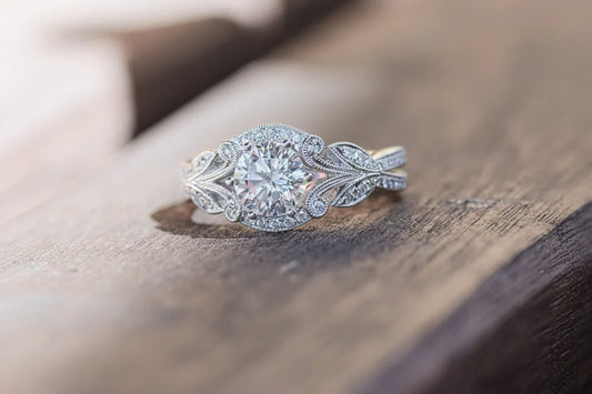 Diamond ring with intricate design on a wooden surface