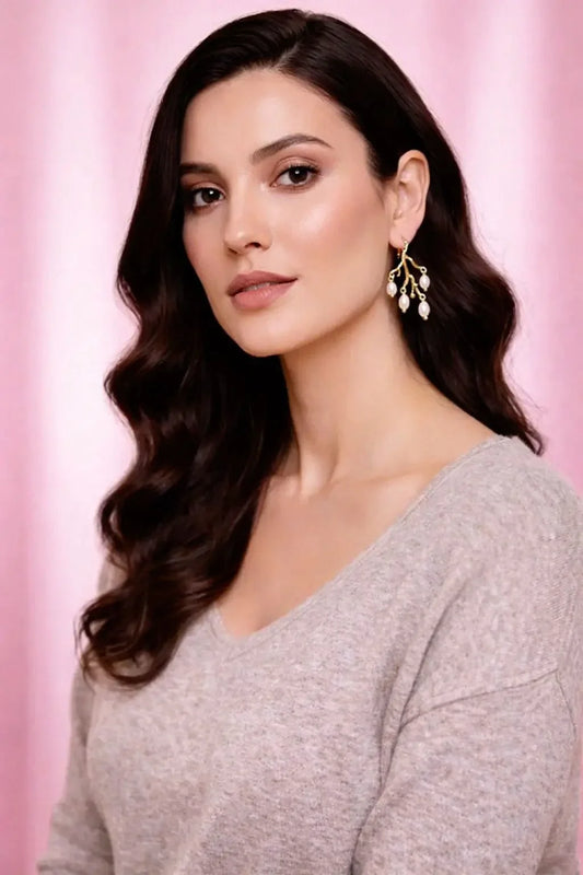 Woman wearing a gray sweater with a pink background