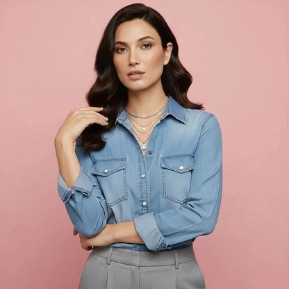 Woman wearing a blue denim shirt against a pink background