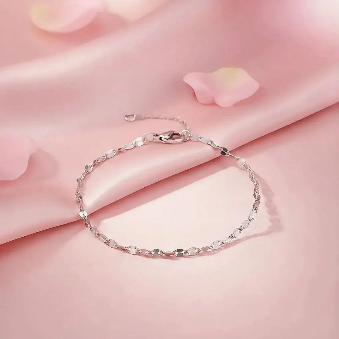 Silver bracelet on a pink fabric background