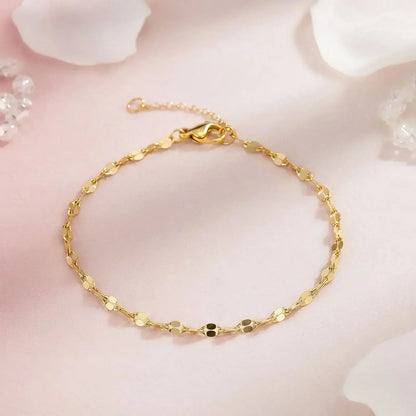 Gold bracelet on a soft pink background