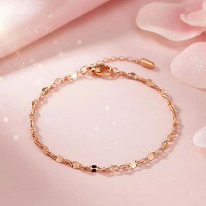 Rose gold bracelet on a soft pink background