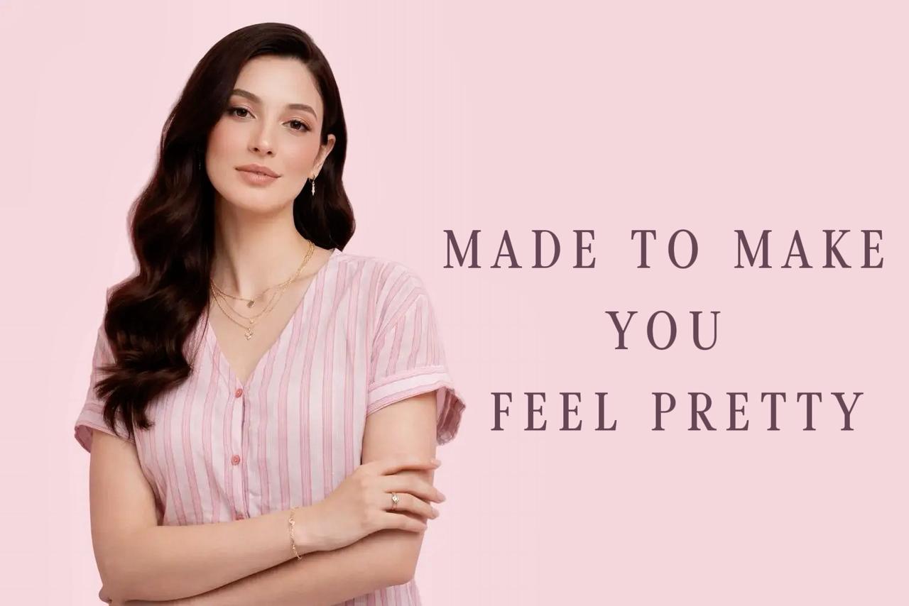 Woman in a striped shirt with text 'MADE TO MAKE YOU FEEL PRETTY' on a pink background