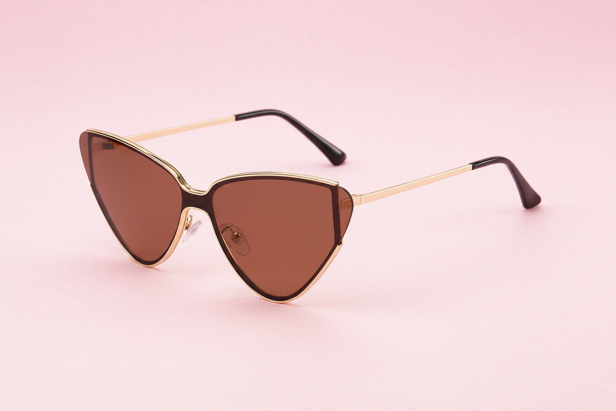 Cat-eye sunglasses with gold frame and brown lenses on a white background