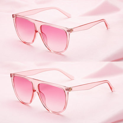 Pink sunglasses with clear frames on a white background