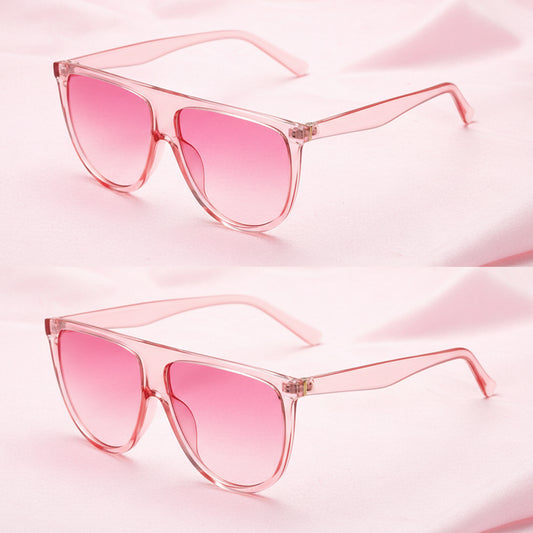 Pink sunglasses with clear frames on a white background