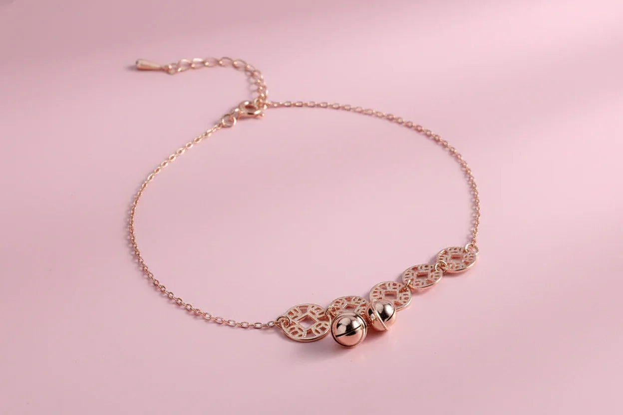 Rose gold bracelet with intricate designs on a magazine page