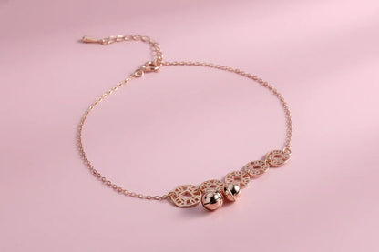 Rose gold bracelet with intricate designs on a magazine page